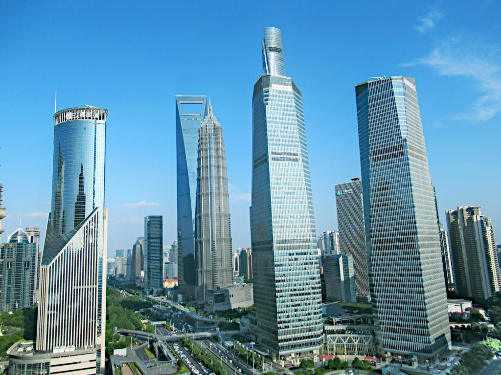 View from the Oriental Pearl Tower in Shanghai of other high-rise buildings including the second tallest building in the world, the sky is perfectly blue with just a few whispers of clouds
