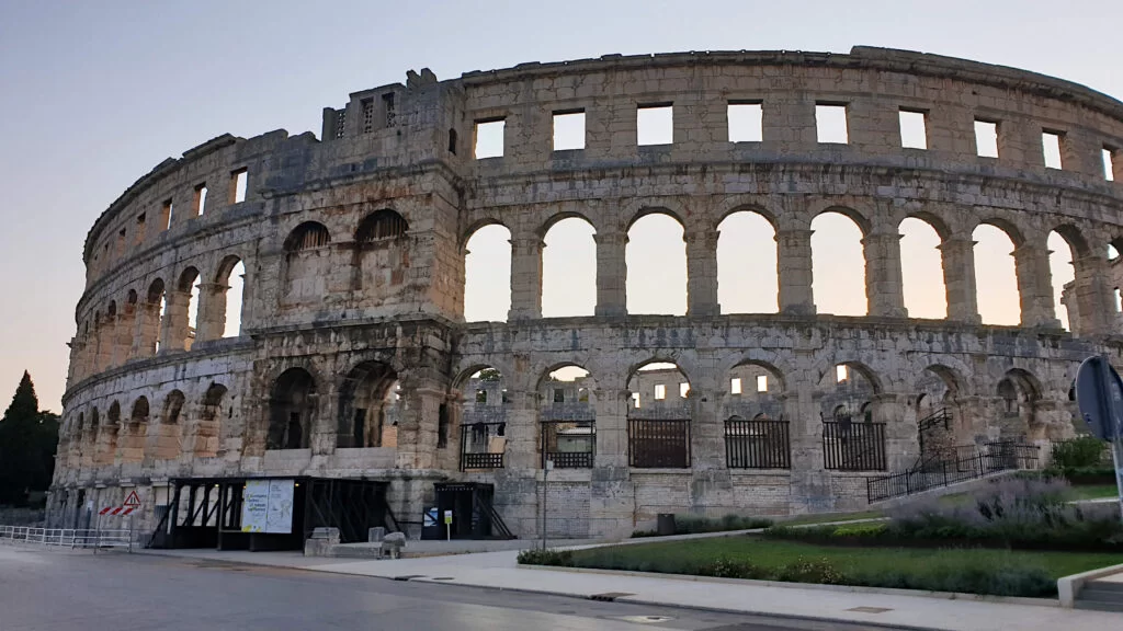 The Pula Ampitheatre at dawn, the gentle light makes the golden stone building glow