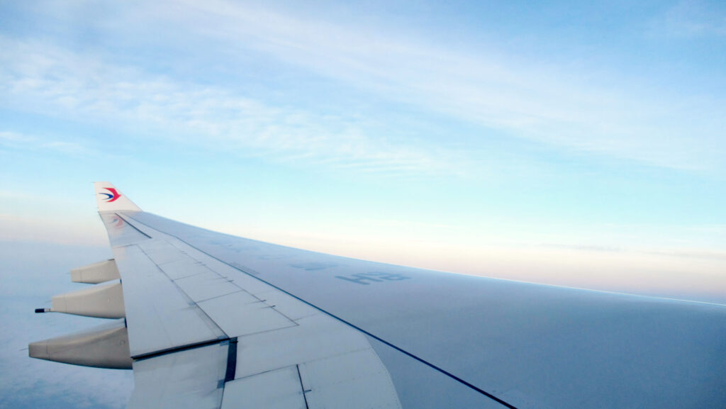 China Eastern plane wing in the sky at dawn.