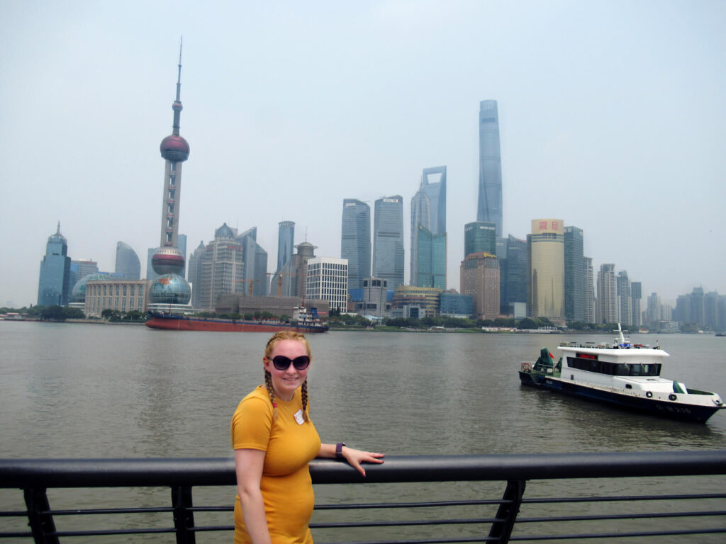 Zoe stood on the Bund in Shanghai. Behind is the famous skyline of Shanghai including the Shanghai TV Tower and Shanghai Tower
