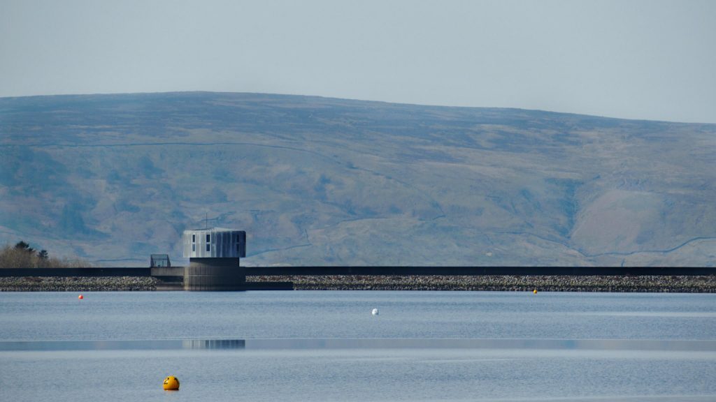 Grimwith Reservoir wall, the walk takes you across this at the end. Rolling Yorkshire Dales hills in the background