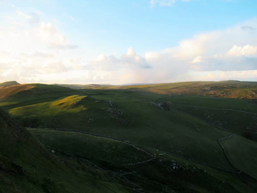 Looking north over the Peak District during this Chrome Hill walk for beautiful rolling hills and blue skies