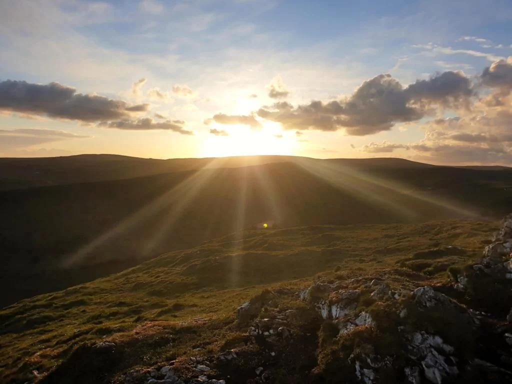 The sun sets over the Peak District with a great view from the top of Chrome Hill. The steep walk up Chrome Hill is worth it for this!