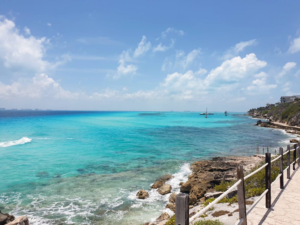 Looking across the water from Punta Sur on Isla Mujeres to Cancun. The water is aqua blue.