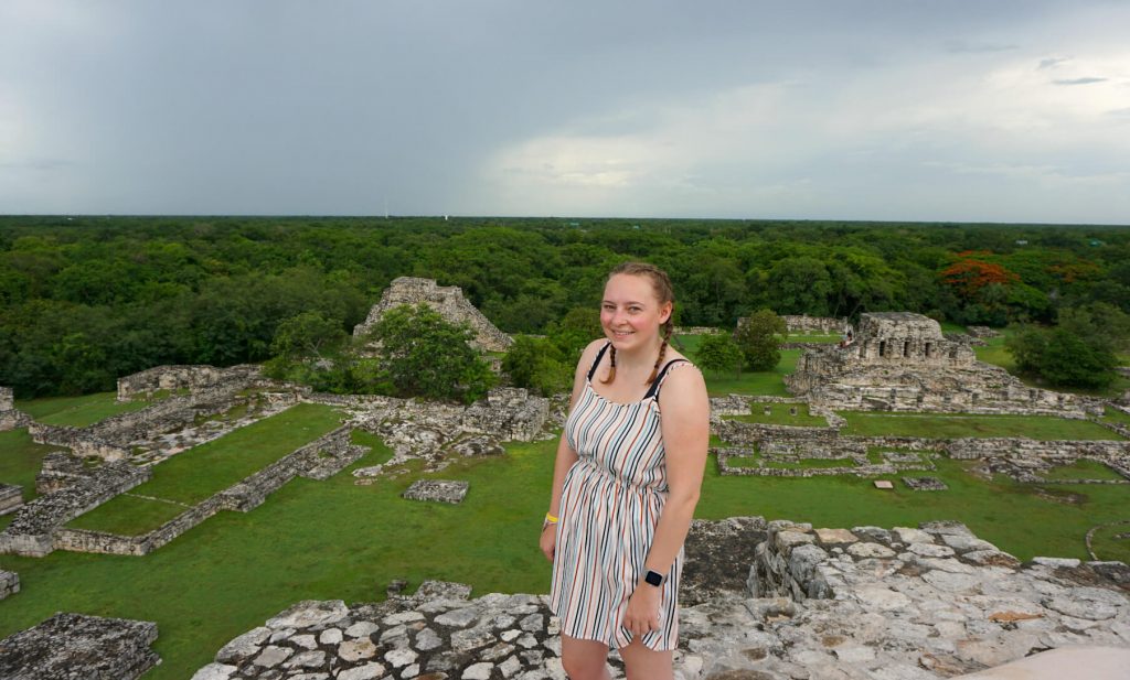 Zoe stood at the top of the main pyramid in Mayapan. Behind her is the dense Yucatan jungle and the remains of a few more stone ruins