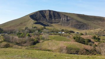 Another great Peak District walk is a circular route from Castleton to Mam Tor. It's sunken south-east face visible in the photo against the pale blue sky and green hills.