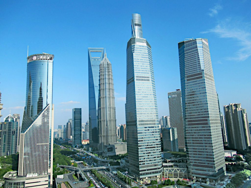 View from the Oriental Pearl Tower in Shanghai of other high-rise buildings including the second tallest building in the world, the sky is perfectly blue with just a few whispers of clouds