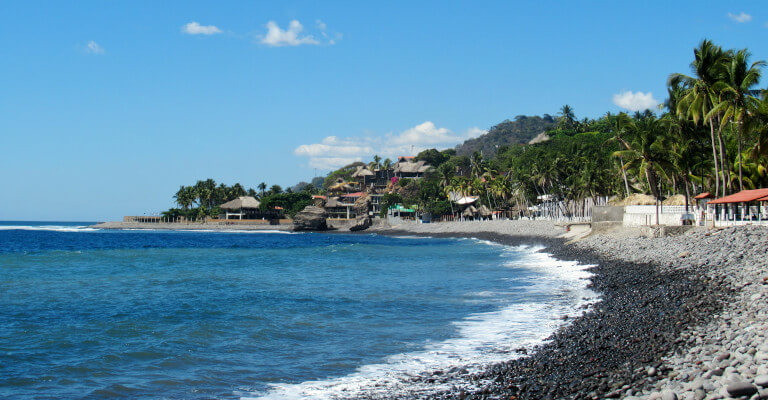 Playa El Tunco on a glorious sunny day with palm trees lining the beach