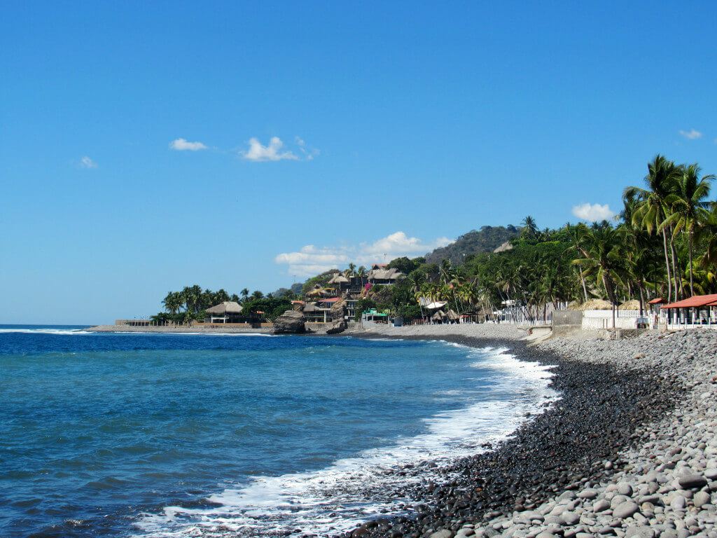 Playa El Tunco on a glorious sunny day with palm trees lining the beach