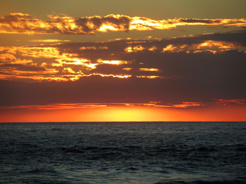 Sunset over the Pacific ocean. Watching sunset is a must-do activity everyday in El Tunco