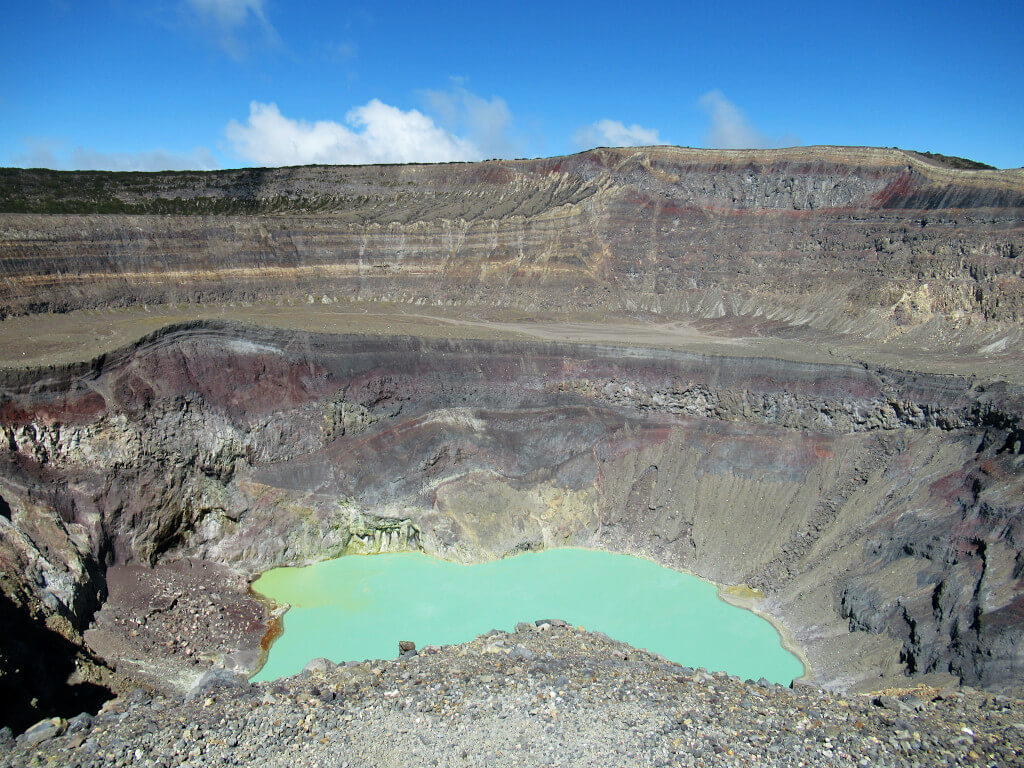 Inside the crater of Santa Ana Volcano is a bright green sulphurous lake. The crater walls are brown, gray and red from thousands of eruptions over the years