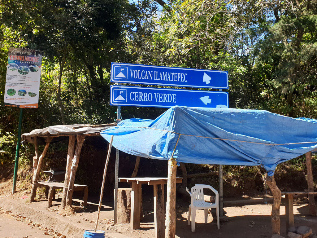 The entry to the Santa Ana Volcano trailhead is at this location, marked by two signs and a covered seating area