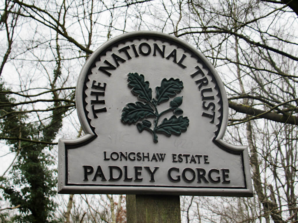 Picture of the National Trust emblem at Padley Gorge. Sign reads: The National Trust, Longshaw Estate, Padley Gorge with a leaf logo in the centre