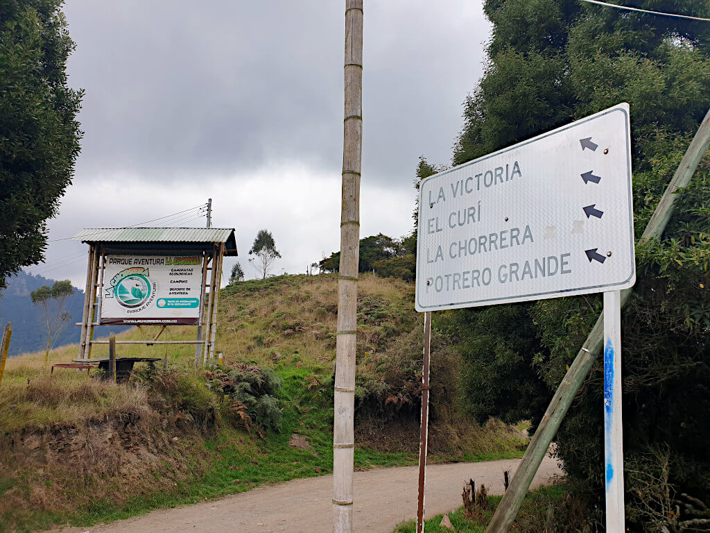 At the roadside, follow the road where this sign is to reach Parque Aventura for the waterfalls