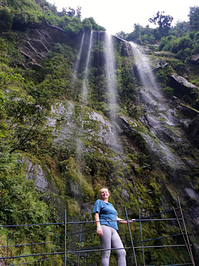 Zoe stood under Cascada La Chorrera, with a stream of fine mist flowing on top of her