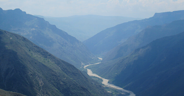 Looking through the canyon with layers of hills rising from the central river