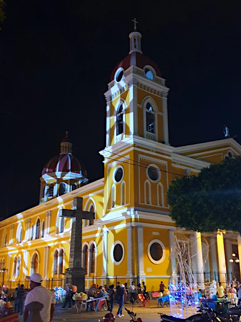 Granada's main cathedral at night with star shapes being shone onto the outside of the building