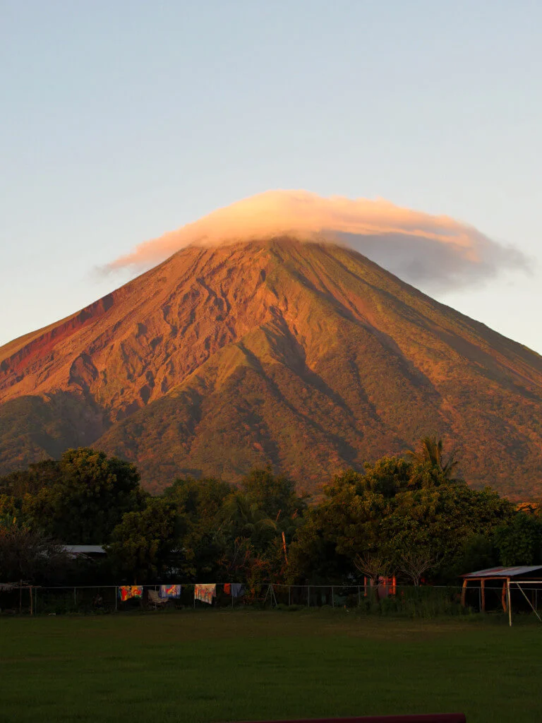 Volcano Concepcion with a mushroom cloud at golden hour