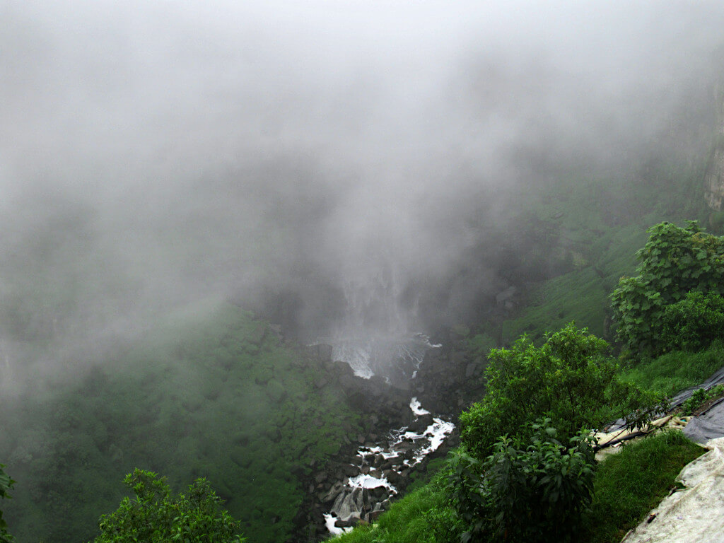 The base of the El Salto del Tequendama Falls, with most of the water obscured by fog