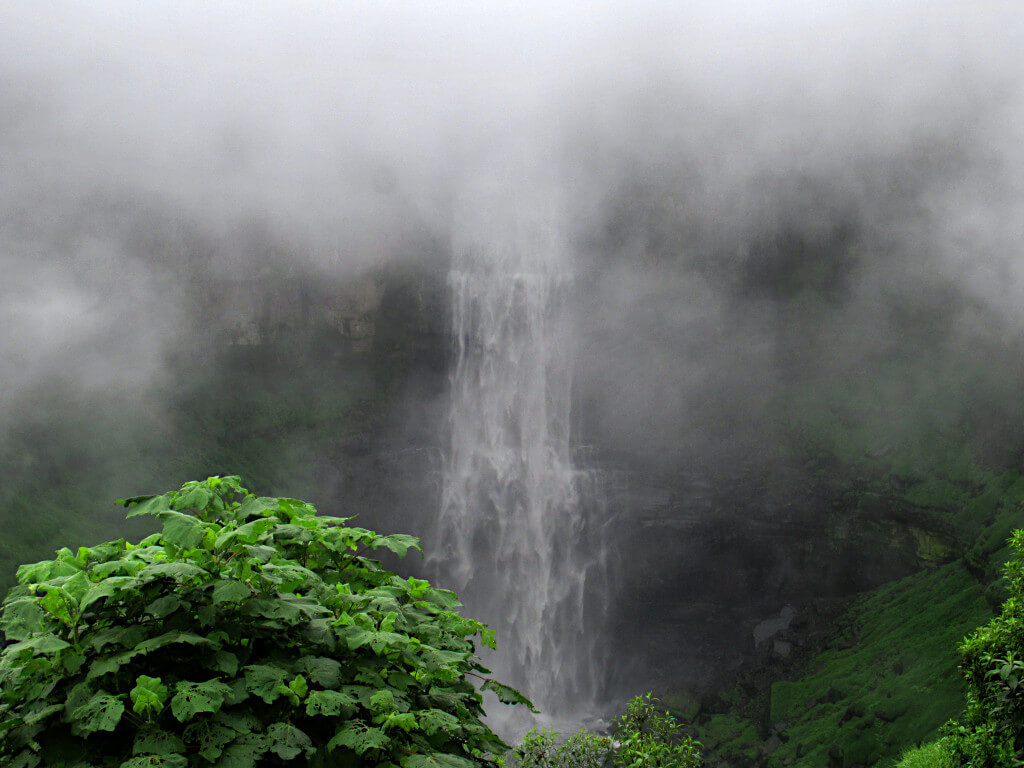 The Salto del Tequendama waterfalls on a foggy day, cloud is covering the top part of the falls