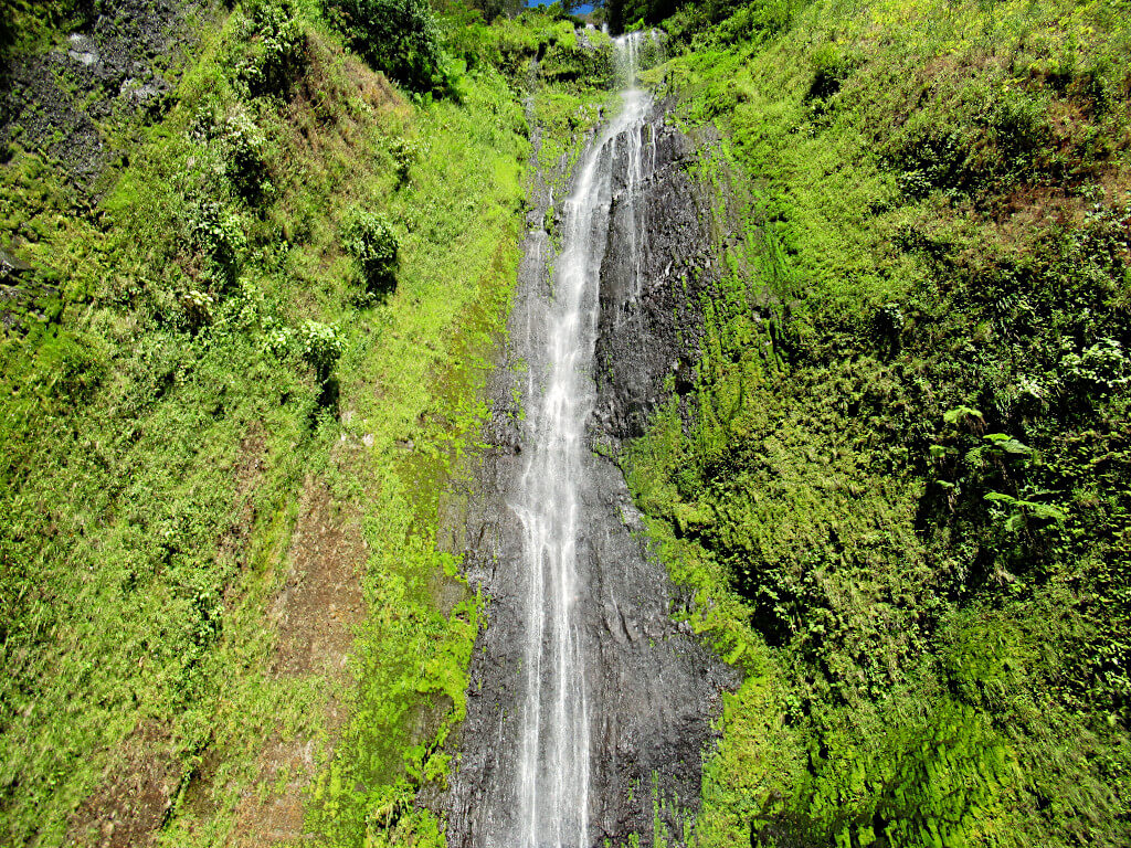 The beautiful San Ramon waterfall in its jungle surroundings, greenery covers all areas of the rock where water doesn't fall