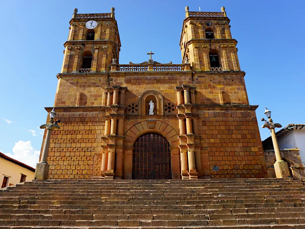 The orange-brick cathedral in the main square of Barichara with a symmetrical design and two towers at the front