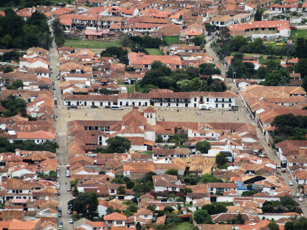Looking down on the town of Villa de Leyva from the hillside viewpoint. The main square and orange rooftops are clearly seen with a zoomed in photo