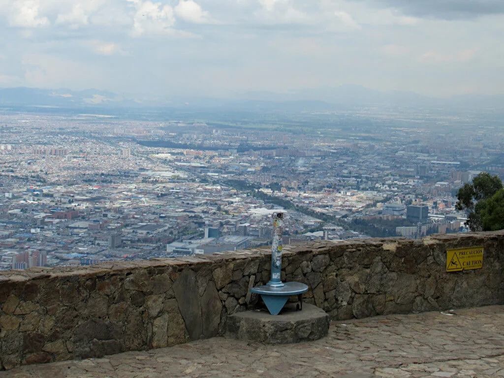 The sprawling city of Bogota, the capital of Colombia. Pictured from the Monserrate viewpoint with a telescope visible at the front of the image