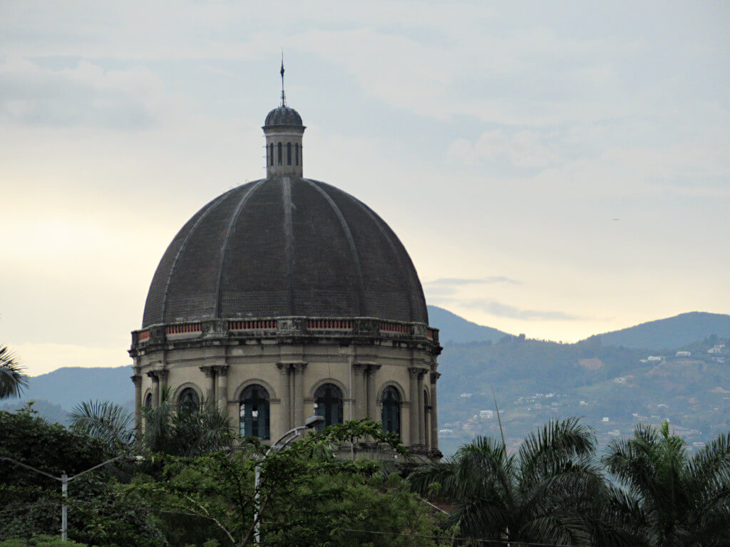 An atypical view of Medellin with a domed building standing against the dusk sky