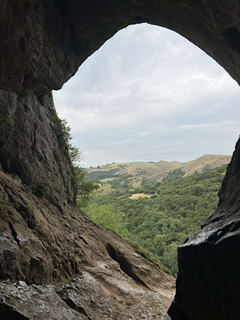 Looking out of Thors Cave through the large opening in the side of the cliff that you walk up