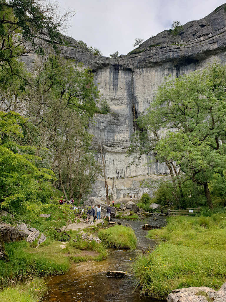 Malham Cove from below with the large rock face a striking feature