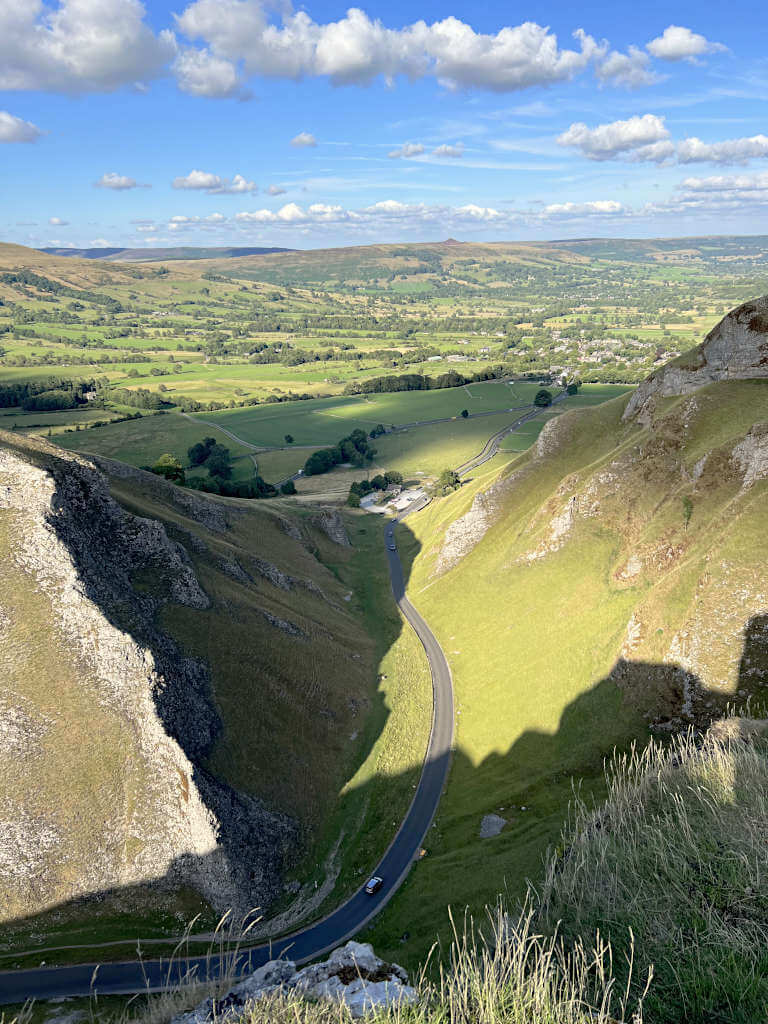 The sun shines down on the steep road as it winds through the valley