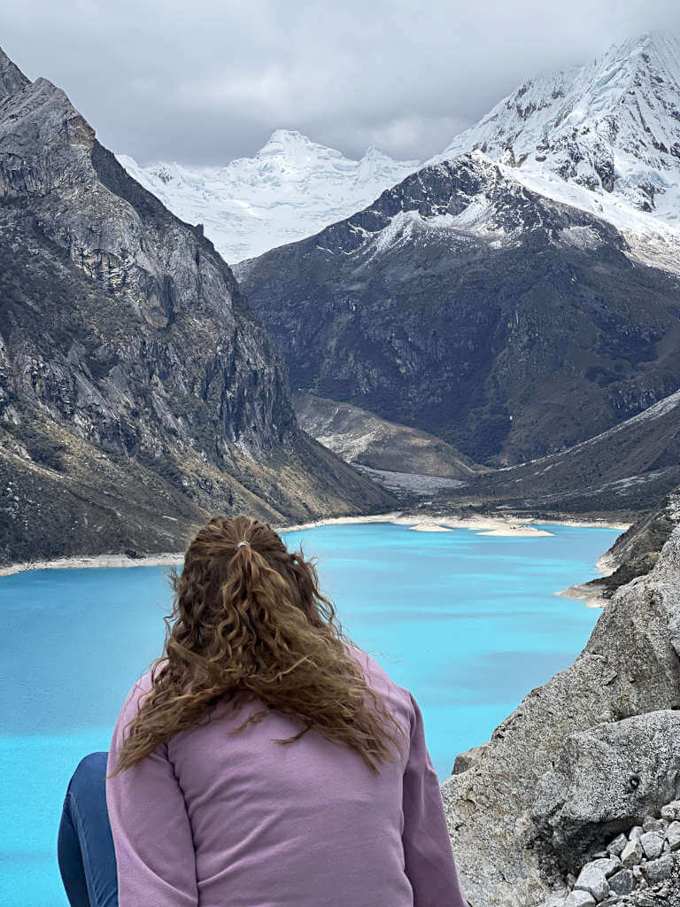 Admiring the vivid colour of the lake and the imposing mountains around