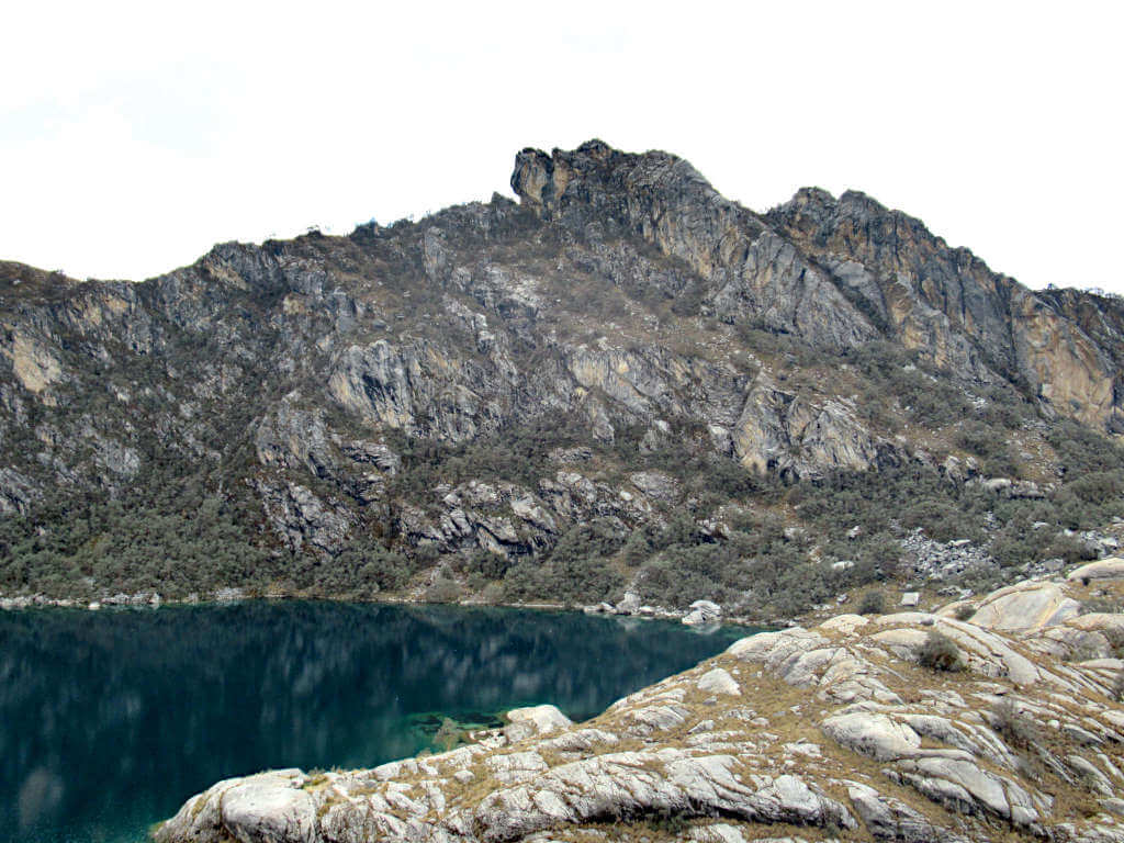 An alternative view of the lake in the other direction from the snowy peak, the water is dark but vivid blue