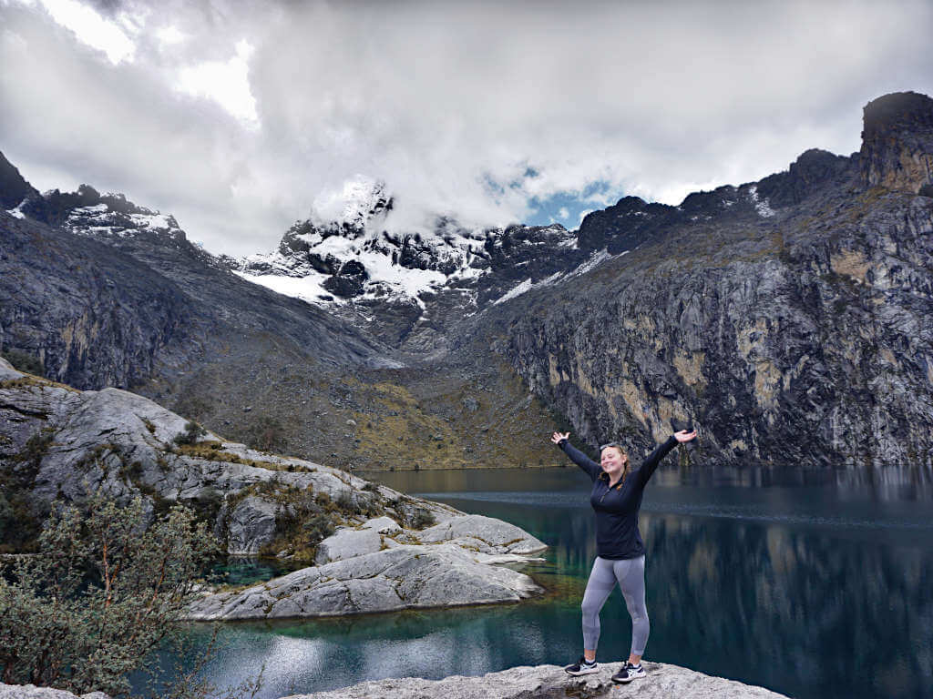 Zoe stood in front of Laguna Churup with the snowy peak behind