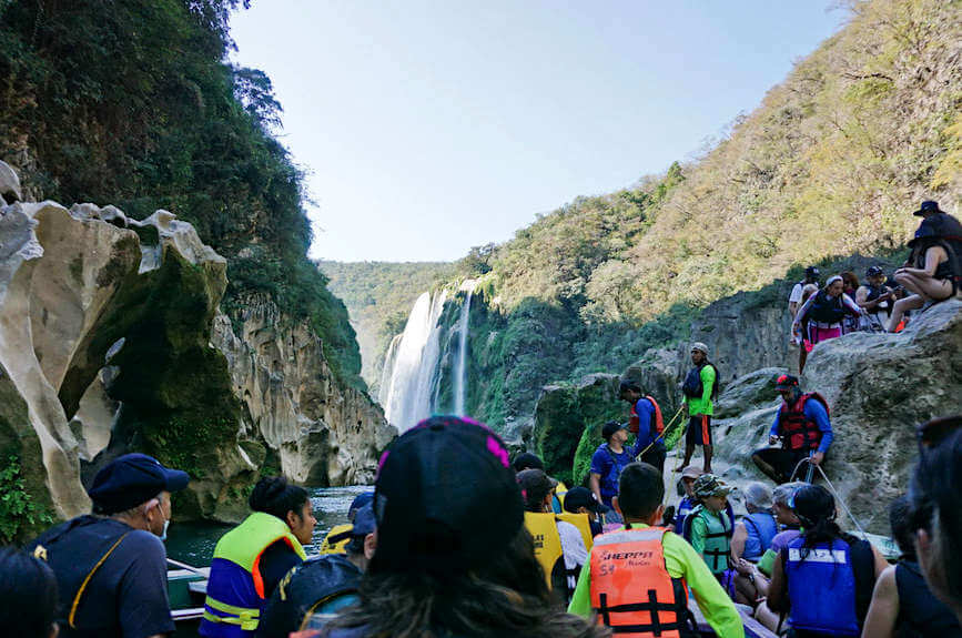 Looking over the heads on a boat trip to one of Mexico's best waterfalls: Cascada Tamul. Located at the end of a steep canyon, a boat trip is essential for the best view