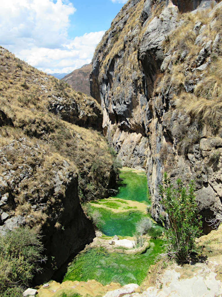 Looking down the cascading pools, which are bright green