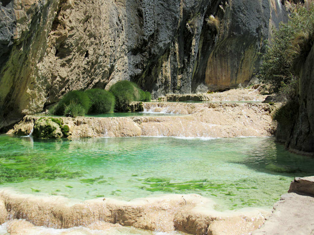 Close up of the bright pools at Millpu Ayacucho with unique shrubbery around