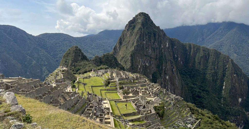 The impressive mountain-top ruins of Machu Picchu, situated above the town of Aguas Calientes in Peru