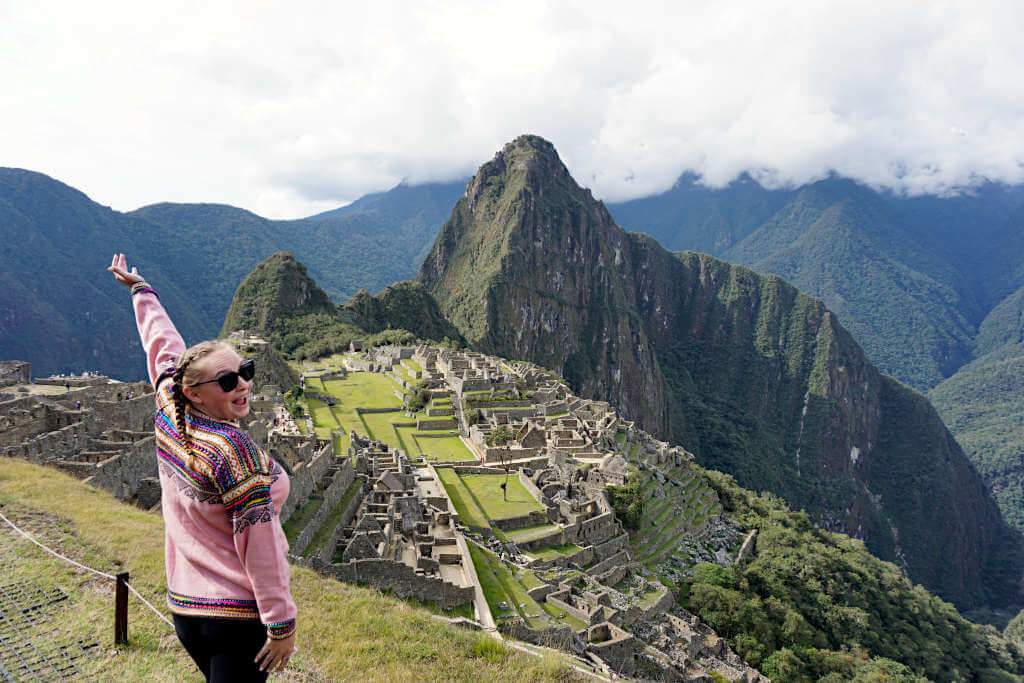 Zoe stood at the lower viewing platform at Machu Picchu with Huayna Picchu and the ruins behind