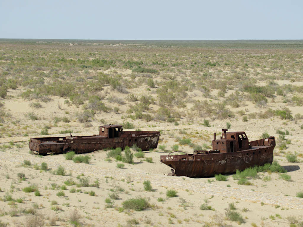 The rusting remains of two ships on a dried out lake bed, which used to be the Aral Sea in western Uzbekistan