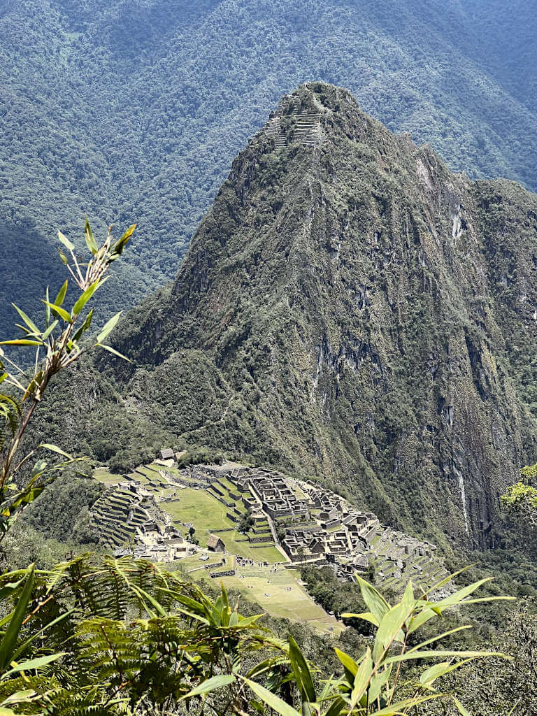 After a difficult climb to the top of the mountain, you'll see these incredible views of the surrounding mountains and small brick ruins below