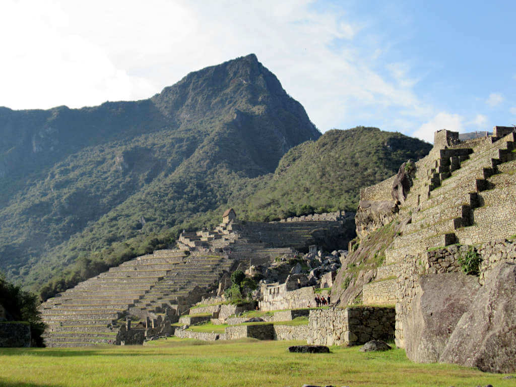 Looking up at Machupicchu mountain with the agricultural zone ruins in the foreground.