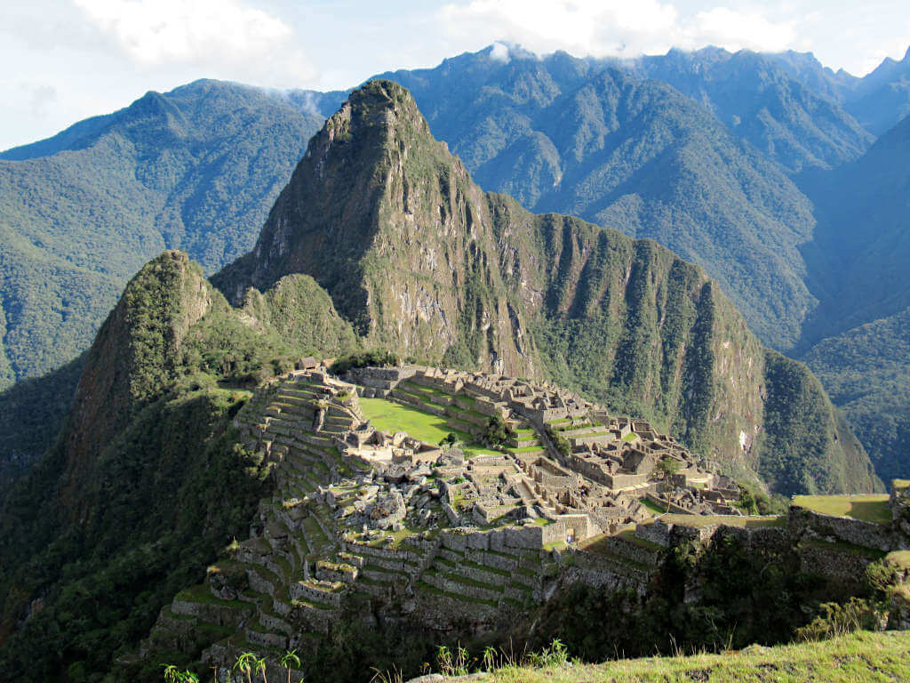Looking down on Machu Picchu from the superior viewing platform. The early morning sun glows around the Inca site