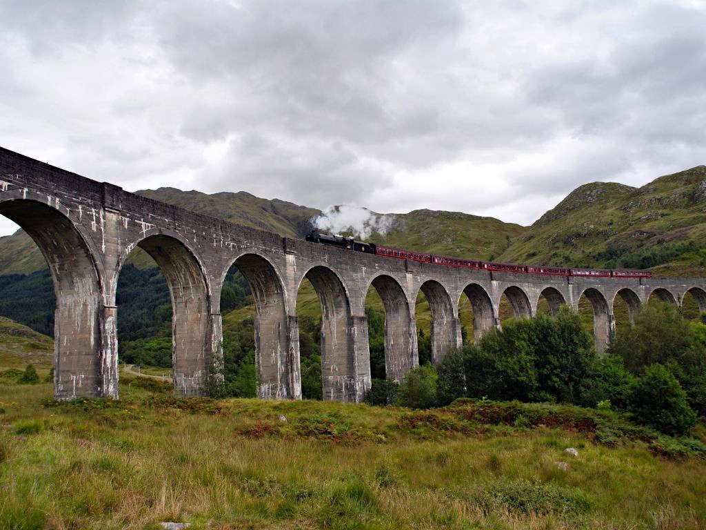 The Jacobite Steam Train crossing the viaduct with steam pouring from the engine carriage