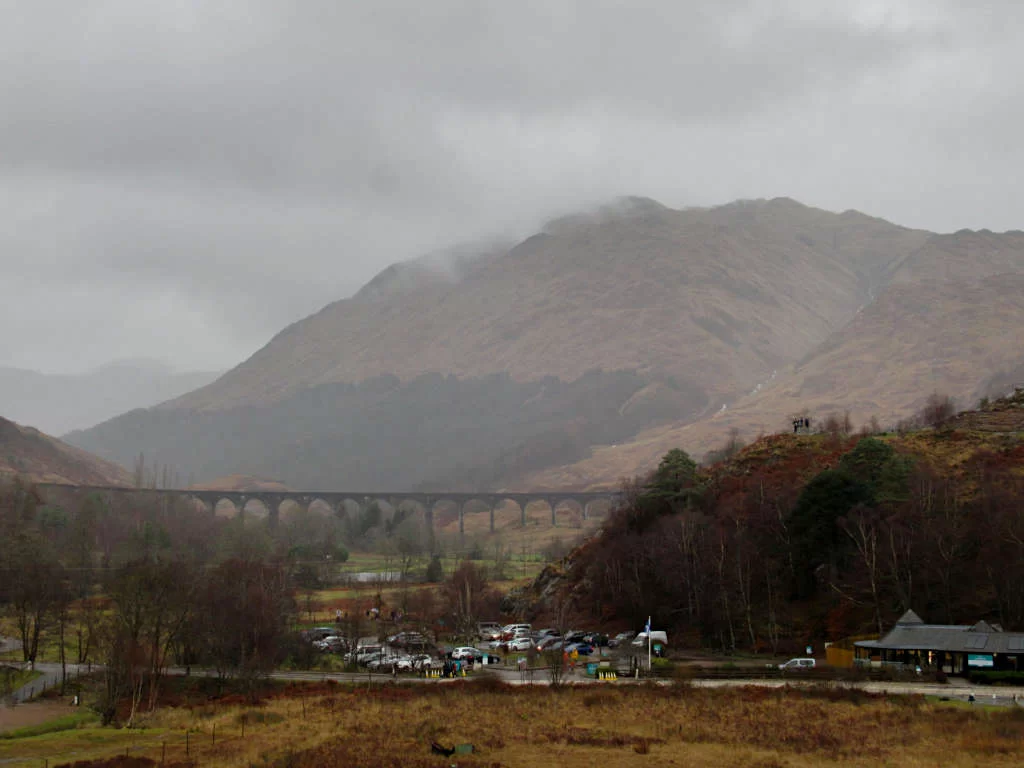 Looking across at the viaduct from the Glenfinnan Monument with the imposing mountains behind with looming cloud