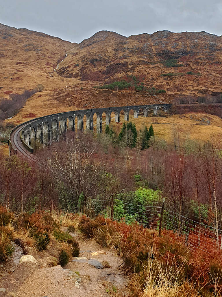 Looking down on the tracks from the most popular Glenfinnan Viaduct Viewpoint and photo spot, where you'll get a great view of the steam train coming from Fort William