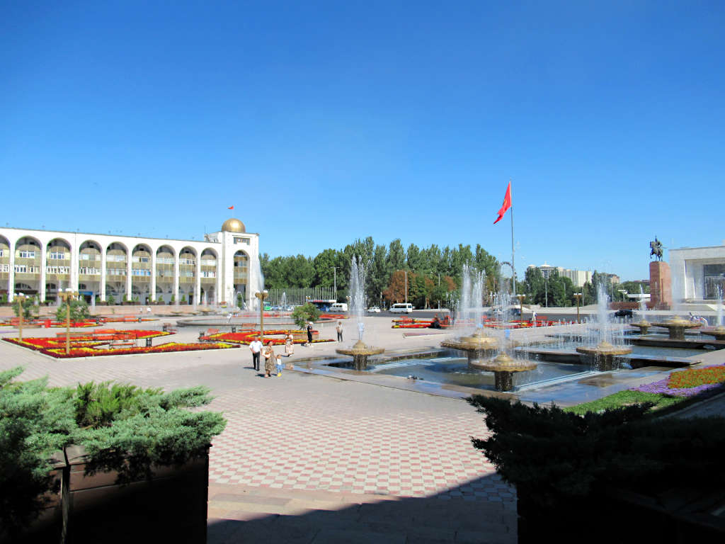 Looking across the square at the fountains, flag and buildings in the background