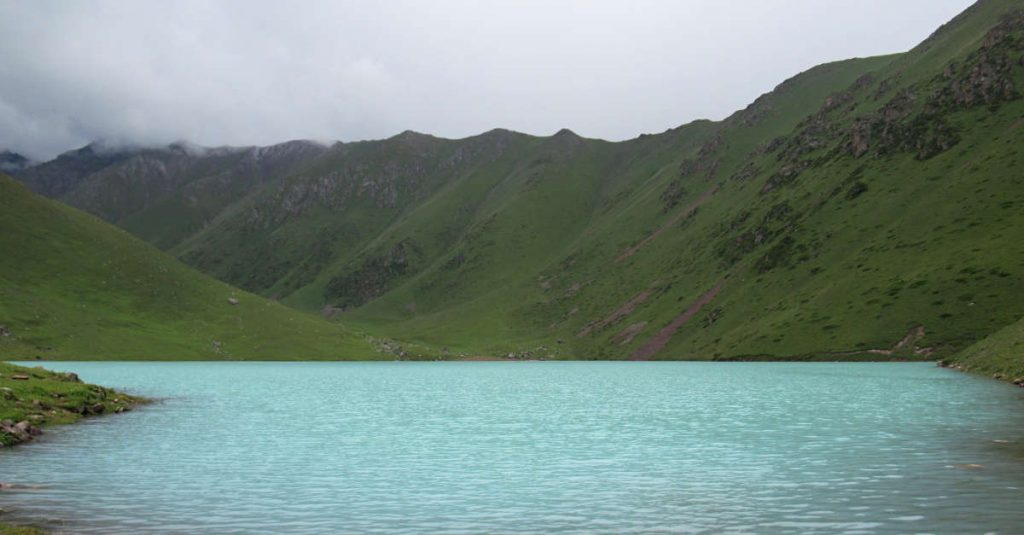 Kol Tor Lake near Bishkek in Kyrgyzstan. Known for its bright blue colour and picturesque background of mountains