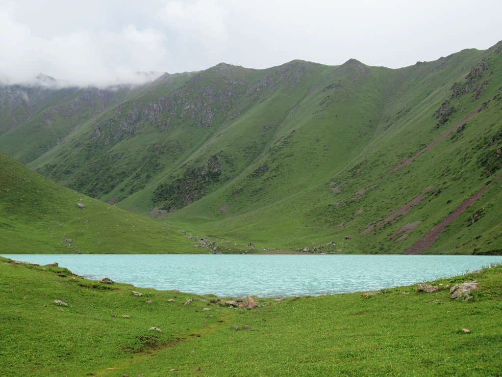 The beautiful Kol Tor Lake with its vivid blue colour and backdrop of mountains